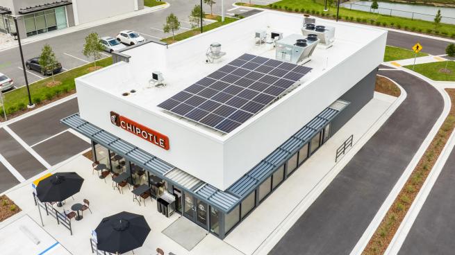 Chipotle’s new sustainable restaurant design includes rooftop solar panels.